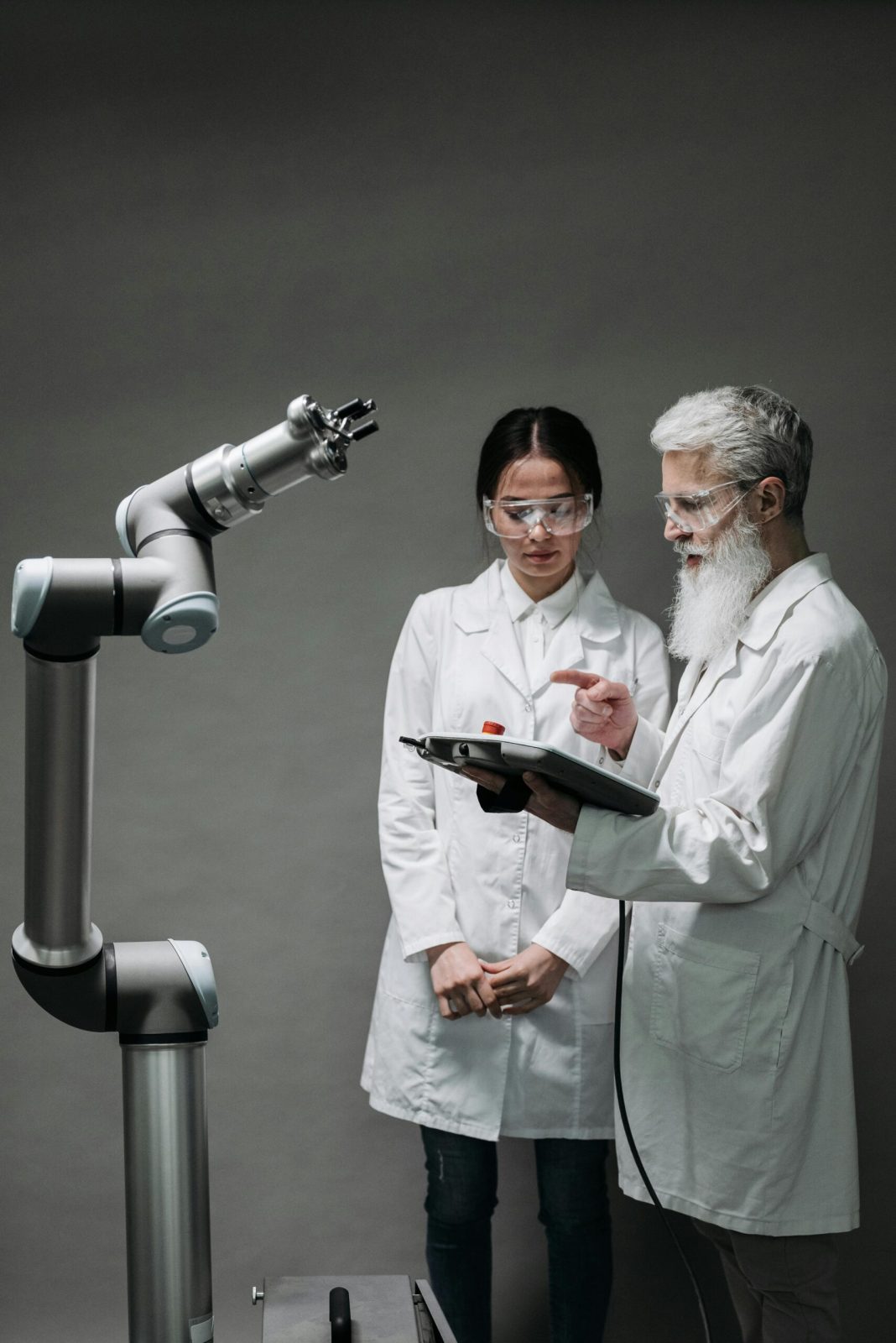 Two scientists discussing robotics research, highlighting technological innovation.